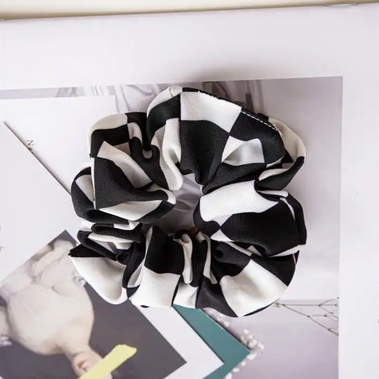 A black and white checkered scrunchie for Formula 1 fans from The Paddock Collection