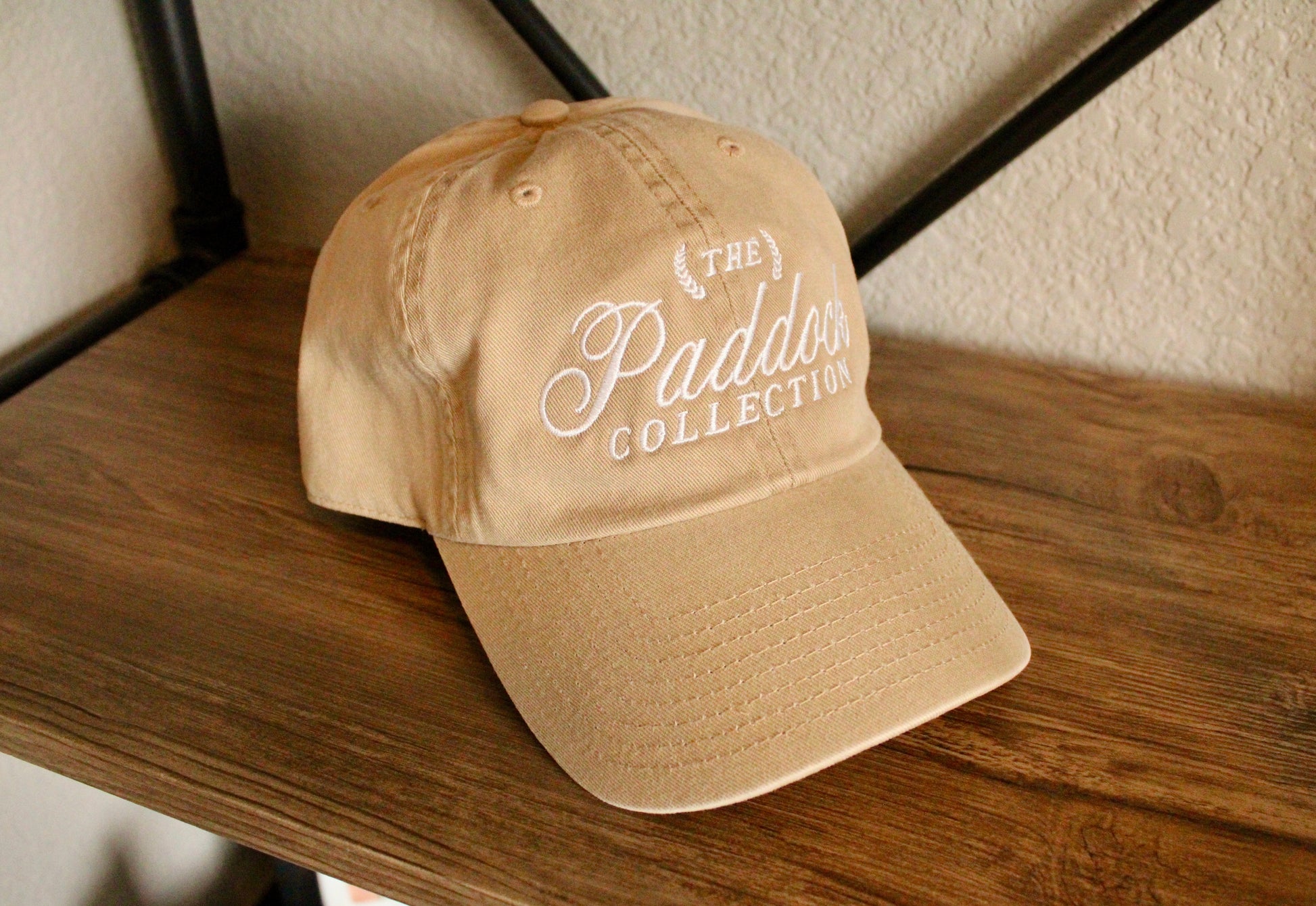 A beige hat with white embroidery The Paddock Collection for Formula 1 fans